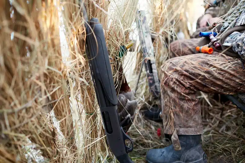 Hunter in camouflage sitting