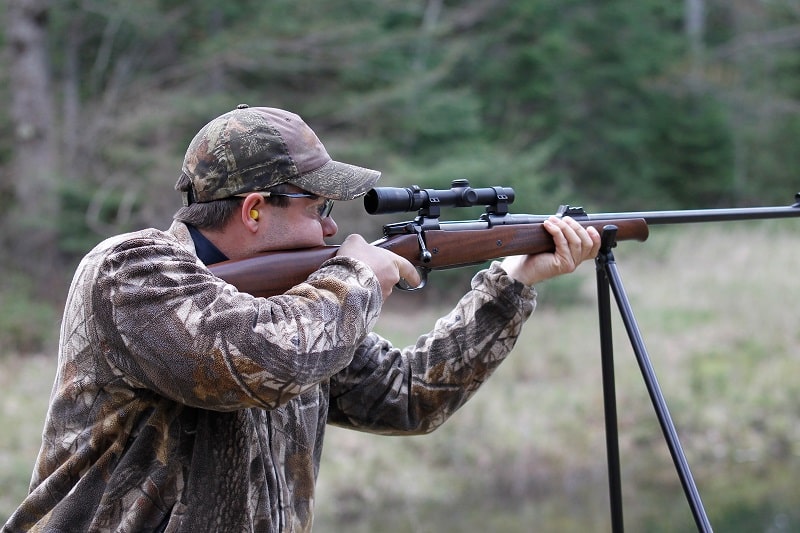 man aiming standing up