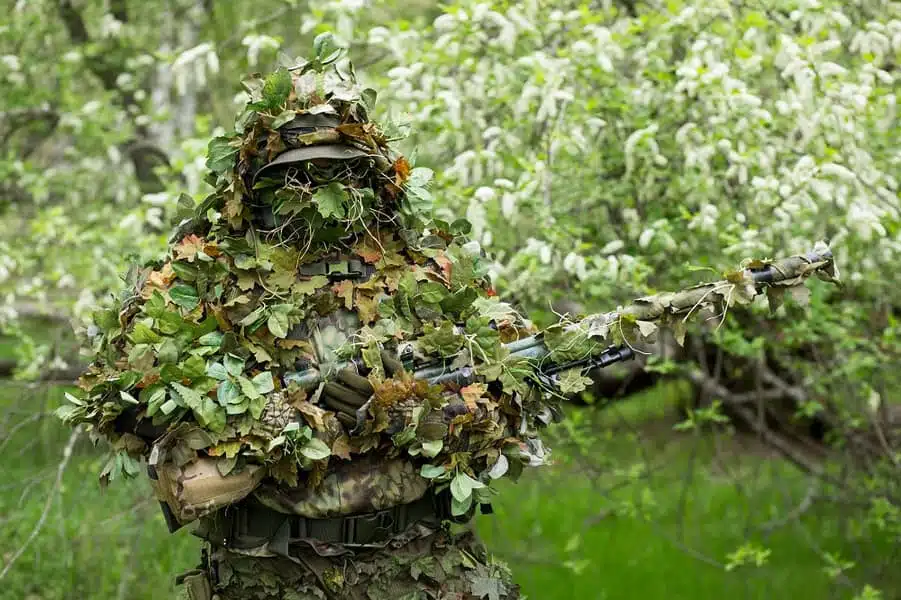 Camouflaged sniper